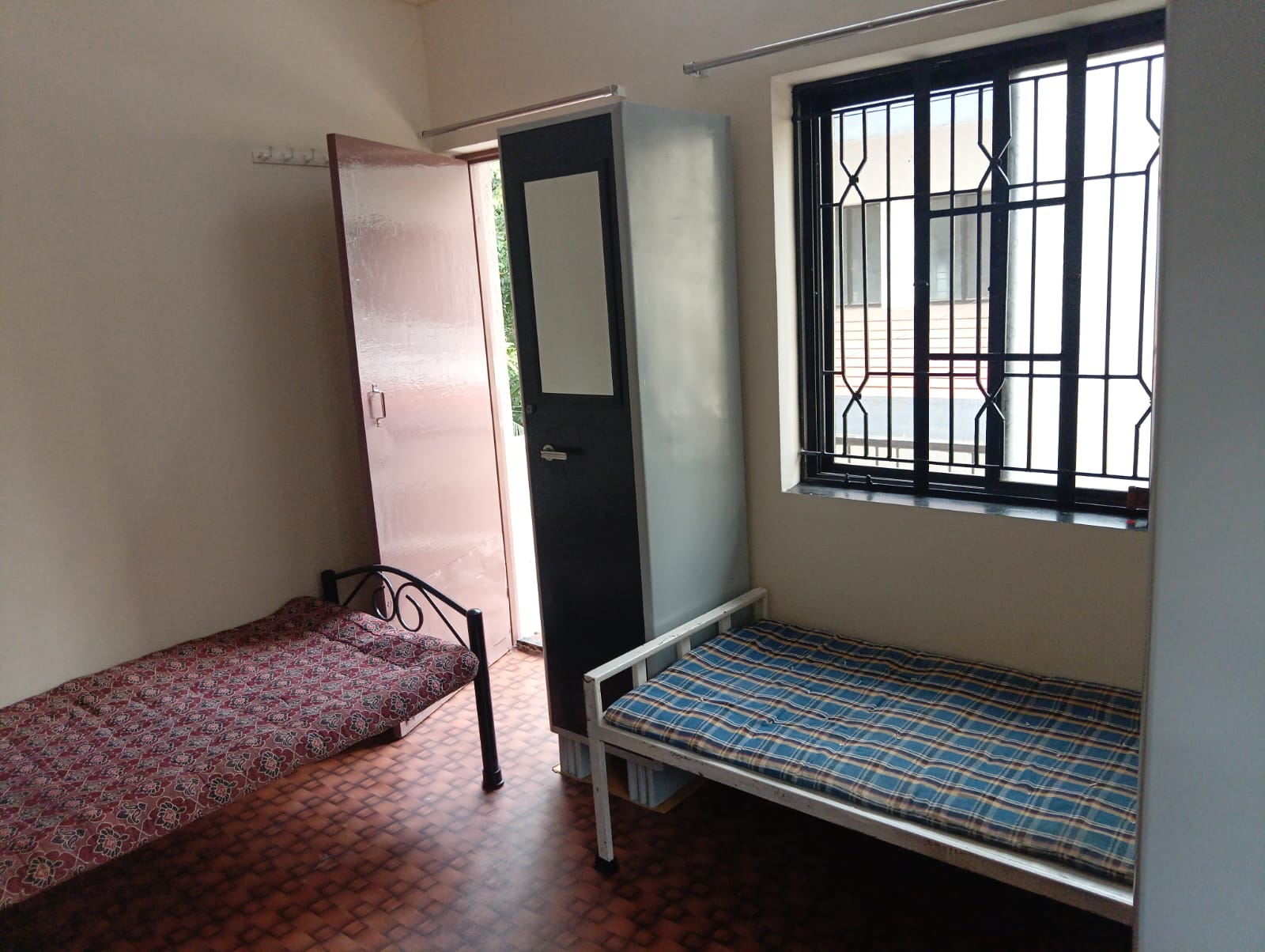 Two beds in double sharing room at Queen Quatters girls PG near PCCOE