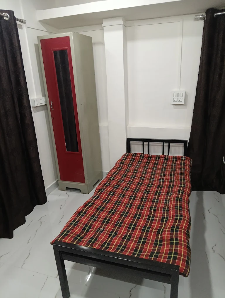 Clean and spacious room interior at Queen Quatters girls PG near PCCOE Nigdi Pune