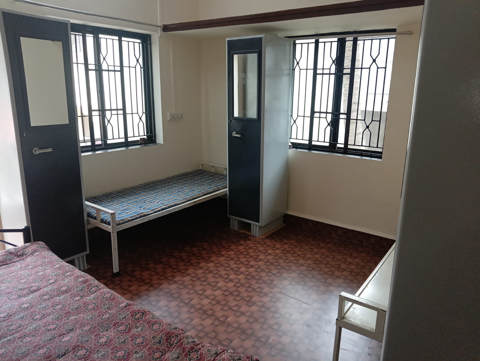Spacious triple sharing room at Queen Quatters girls hostel Nigdi
