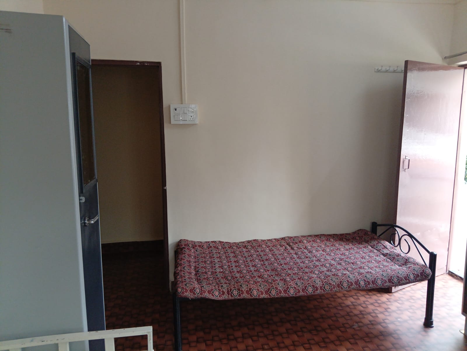 Room with direct balcony access at Queen Quatters PG Nigdi Pune